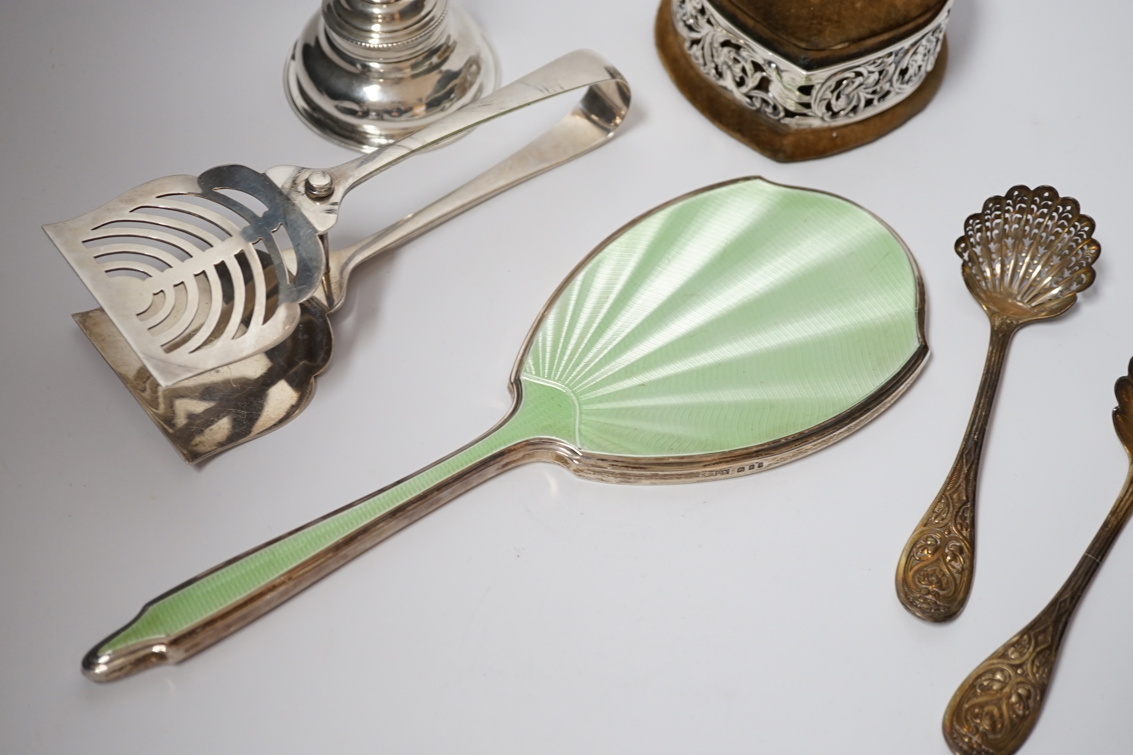 A Georgian silver wine funnel, 11.7cm (a.f.), a pair of silver servers, a pair of Victorian silver sifter spoons, George Adams, London, 1859, a silver and enamel mounted hand mirror and a George V pierced silver mounted